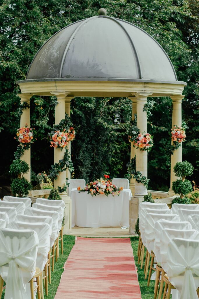 an empty wedding aisle leading to a gazebo