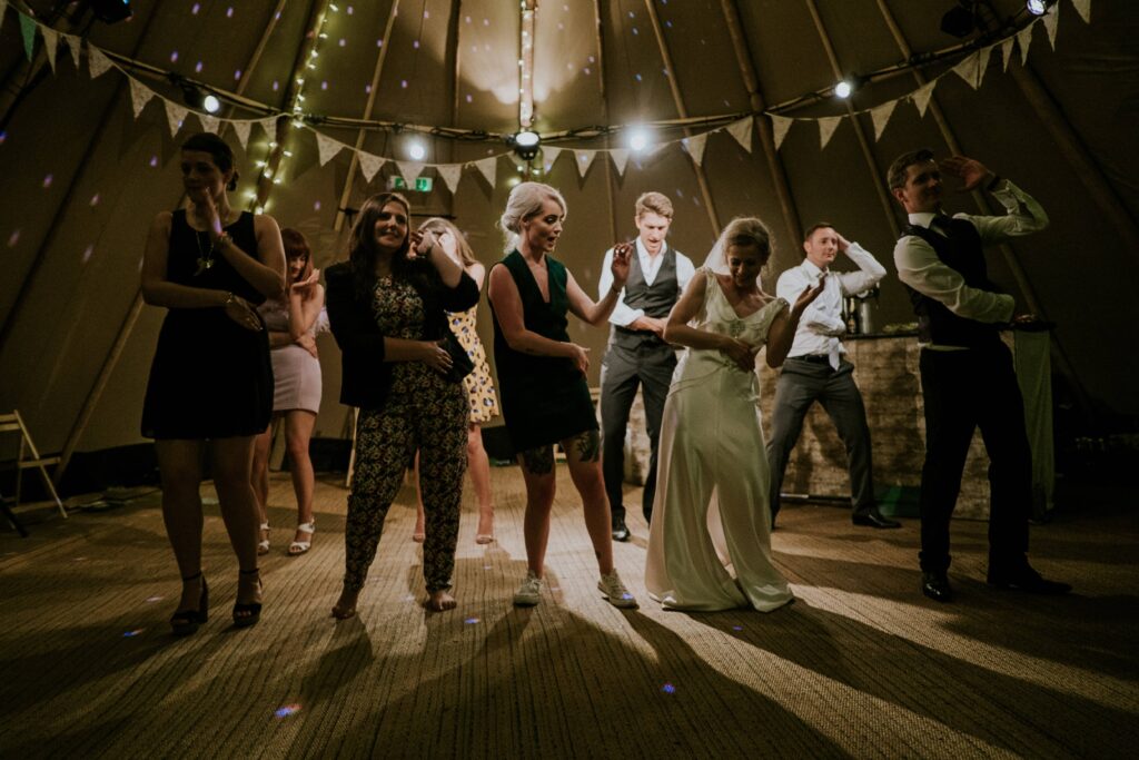 a dimly lit dance floor at a wedding